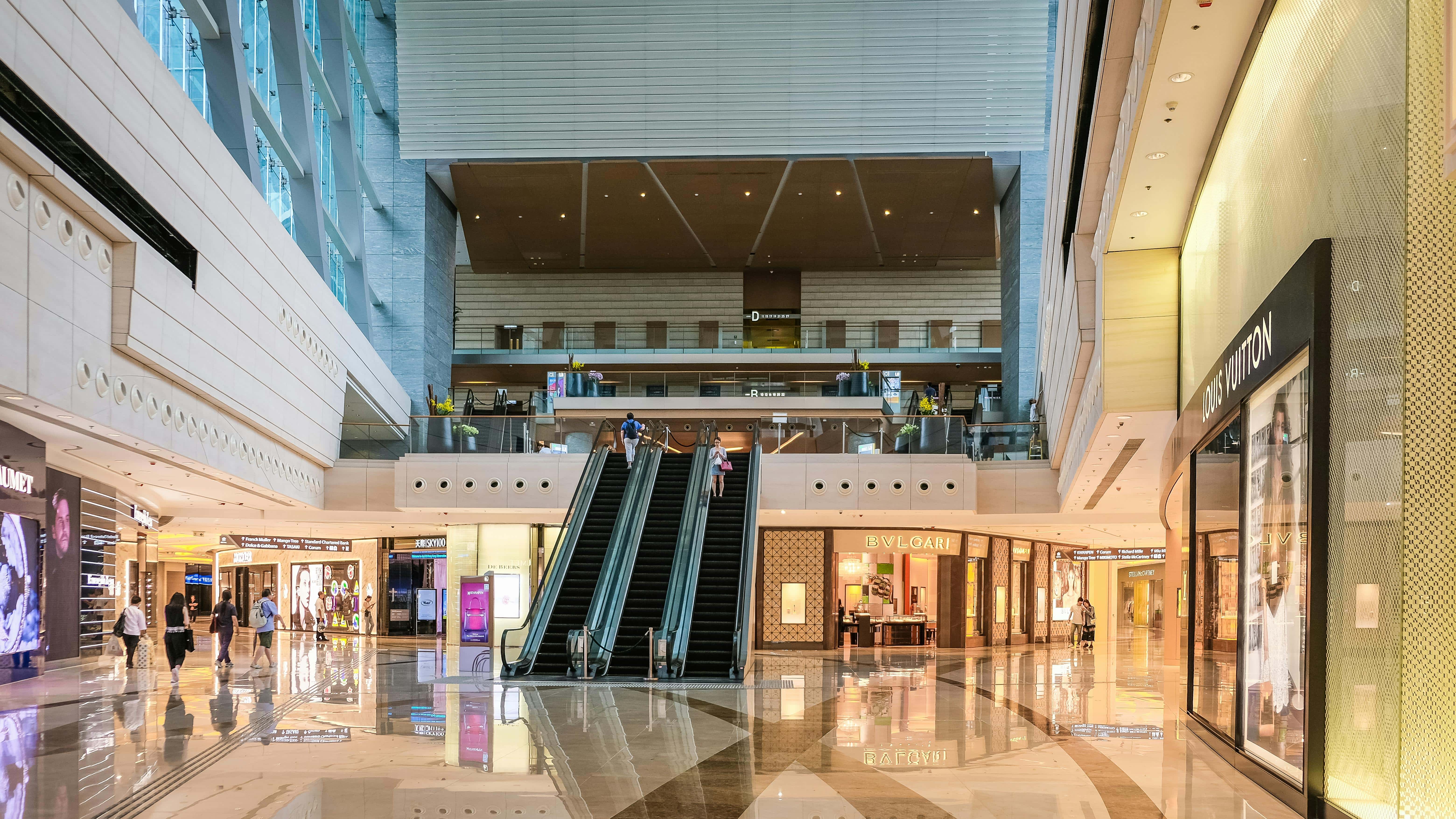 Bright, upscale shopping mall in Ontario featuring high-end boutiques and lively shoppers.