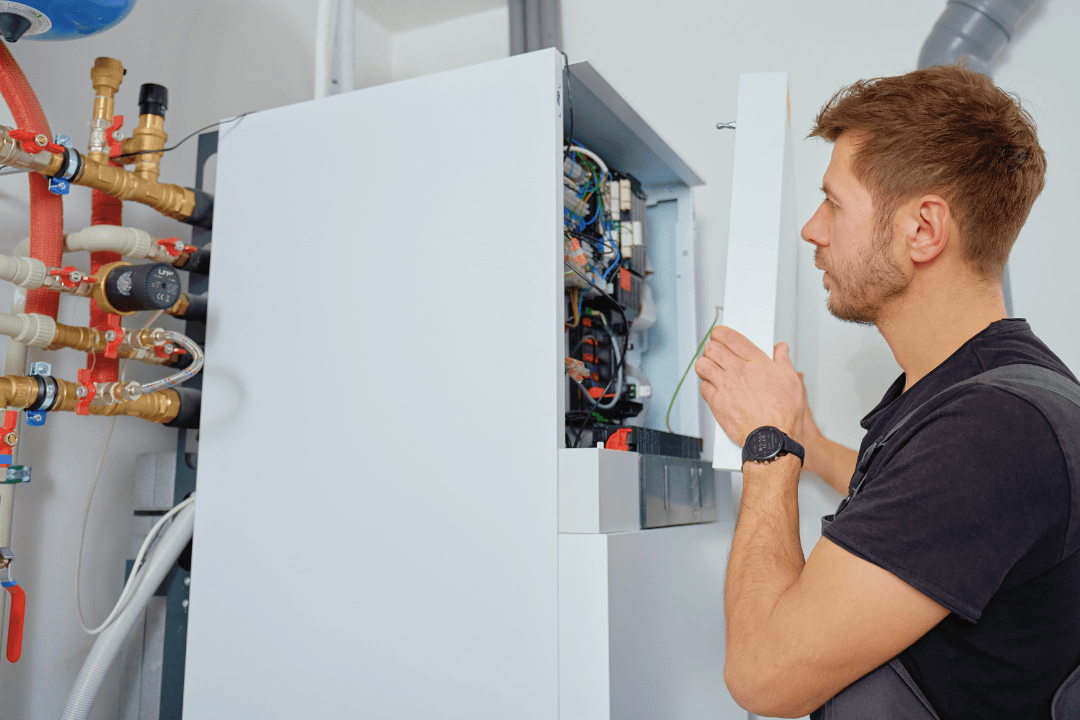 Technician performing preventive maintenance on heating and mechanical systems in a Vancouver strata building.